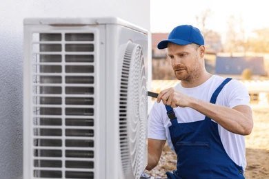 Technician repairing an HVAC system to restore heating and cooling efficiency